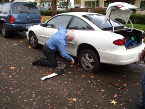 Jeff helps new employee with flat tire.